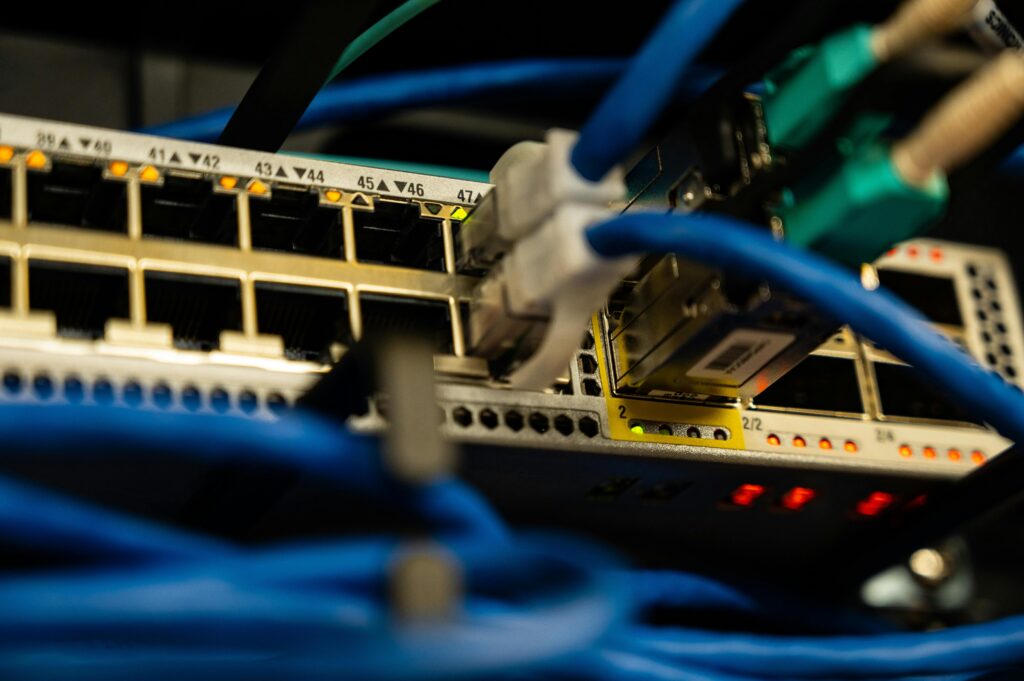 Close-up image of ethernet cables plugged into a network switch, showcasing IT infrastructure.